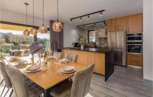 a kitchen and dining room with a table and chairs at Awesome Home In Boljun With Wifi in Boljun