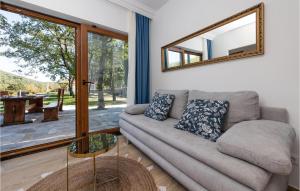 a living room with a couch and a mirror at Lovely Home In Gruda With Wifi in Gruda