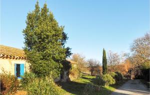 a house with a tree next to a road at Beautiful Home In Pech-Luna With Wi-Fi in Pech-Luna +15 photos