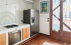 a kitchen with a stainless steel refrigerator next to a window at Nice Apartment In Manfredonia With Wifi in Manfredonia +6 photos