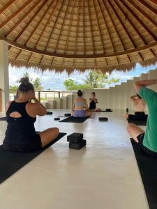 a group of people sitting on the floor in a yoga class at Meraki in Polhena +60 photos