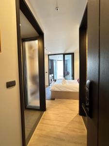 a door leading to a bedroom with a bed at Edge centarl pattaya luxury sea view in Ban Khok Kham +3 photos