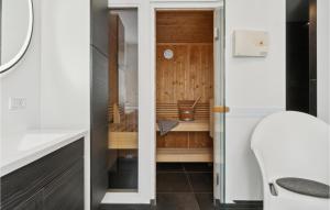 a small bathroom with a sink and a toilet at Holiday Home Ringmosevej Holbæk V in Kisserup