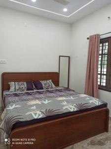 a bedroom with a bed in a room at Malpe Heights - Home Stay in Malpe
