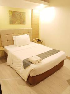 Ένα ή περισσότερα κρεβάτια σε δωμάτιο στο Chambre Hotel Mactan