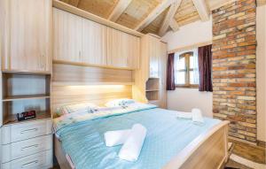 a bedroom with a bed with two towels on it at Beautiful Home In Lovran With Kitchen in Lovran