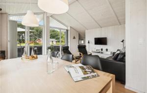 a living room with a table and a couch at Holiday Home Sydals With Hot Tub Vii in Sarup