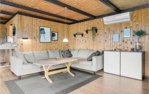 a living room with a couch and a table at Holiday Home Egernsund With A Fireplace 320 in Egernsund