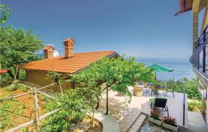 a house with a view of the ocean at Beautiful Home In Lovran With Kitchen in Lovran +32 photos
