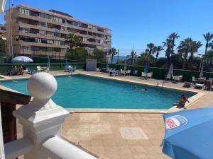a swimming pool with people in a hotel at Apartment-House La Mata Torrevieja in Torrevieja