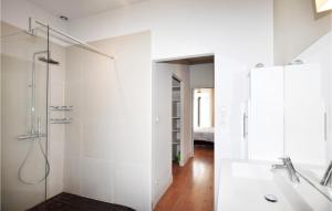 a white bathroom with a shower and a sink at Gorgeous Home In Perpignan in Perpignan