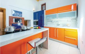 a kitchen with orange and blue cabinets at Holiday Home Pod Gospom Iii in Trsteno