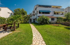 a walkway in front of a house at 3 Bedroom Beautiful Apartment In Krk in Krk