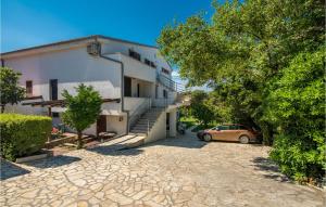 a car parked in front of a building at 3 Bedroom Beautiful Apartment In Krk in Krk