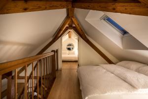 a attic bedroom with a bed and a staircase at Airhome Zug Neugasse Stadtzentrum in Zug