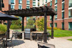 a patio with a grill and tables and chairs at Homewood Suites by Hilton Hartford South-Glastonbury in Glastonbury