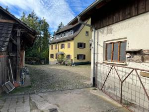a building with a gate in front of a house at HofamHohlebach in Neuenburg am Rhein