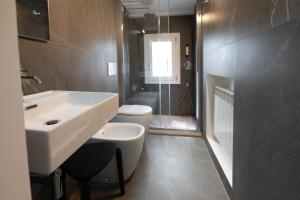 a bathroom with a sink and a toilet and a shower at Inn Urbe Colosseo in Rome +113 photos