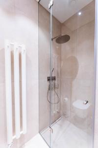 a shower with a glass door in a bathroom at Silvie Apartments - Vídeňská in Olomouc
