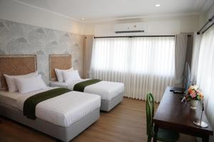 Ένα ή περισσότερα κρεβάτια σε δωμάτιο στο Mongkhon Boutique Hotel +38 φωτογραφίες