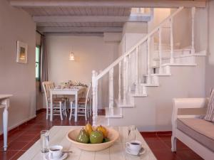 a living room with a table with a bowl of fruit at Mythos Suites Boutique Hotel in Rethymno