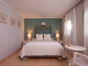 a bedroom with a large bed with a green headboard at Mythos Suites Boutique Hotel in Rethymno