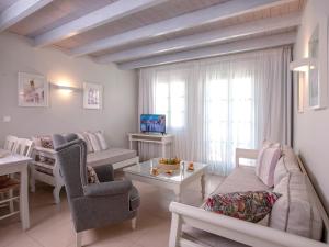 a living room with a couch and a table at Mythos Suites Boutique Hotel in Rethymno