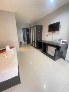 a hotel room with a bed and a desk at Holiday Home Patong in Patong Beach