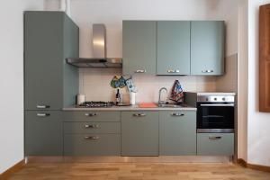 a kitchen with gray cabinets and a stove at Sotto La Torre in LʼAquila