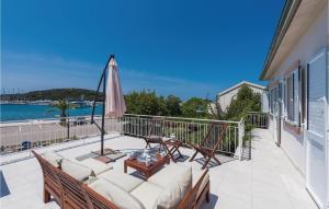 a balcony with a patio furniture and an umbrella at Three-Bedroom Apartment In Rogoznica in Rogoznica
