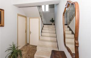 a staircase in a home with a wooden stair case at Three-Bedroom Apartment In Rogoznica in Rogoznica +16 photos