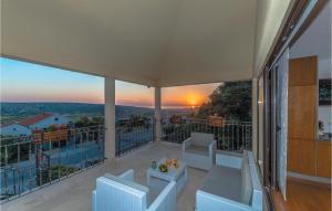 a balcony with a view of a sunset at 1 Bedroom Awesome Apartment In Kolan in Kolan