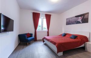 a bedroom with a bed and a tv and a chair at Nine-Bedroom Holiday Home In Arbanija in Trogir