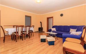 a living room with a blue couch and a table at 3 Bedroom Gorgeous Apartment In Grizane in Grižane
