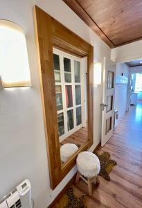 a hallway with a mirror and a stool in a room at Acogedor apartamento en Edif. Slalom II in Monachil