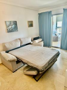 a large bed and a couch in a room at Beautifull Apartment in Benidorm in Benidorm