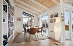 a dining room with a table and chairs and windows at Gorgeous Home In Haderslev With Wifi in Haderslev