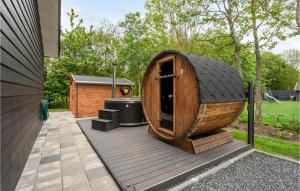 a small wooden boat sitting on a wooden deck at Stunning Home In Hemmet With Wifi in Hemmet