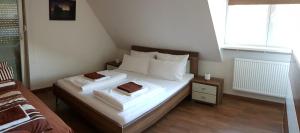 a bedroom with a bed with white sheets and pillows at Ferienwohnung Michelle mit Balkon für 1 - 6 Personen in Warmensteinach