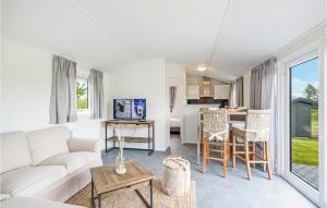 a living room with a couch and a table at Chalet 8 Am See in Süsel