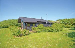 a small house on a hill with a grass field at Holiday Home Hellesvej Vestervig Denm in Vestervig