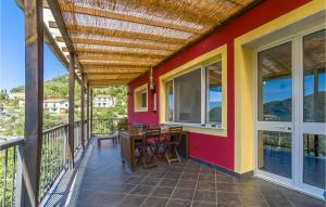 a patio with a table and chairs on a balcony at Casa Relax In Collina in Castiglione Chiavarese