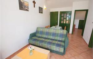 a living room with a couch and a table at Nice Apartment In Malinska in Malinska