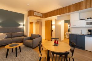 a living room with a couch and a table at Postmaster Hotel in Rovaniemi