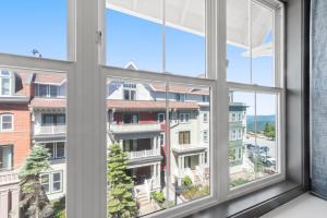 an open window with a view of a building at Expedition Station 313 Next To Slopes And Bike Trails WiFi Village in Snowshoe