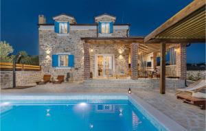 a villa with a swimming pool in front of a house at Villa Stella Del Lago in Vrana