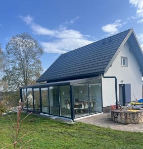 a house with a conservatory with a roof at Holiday house Gradišče in Škofljica