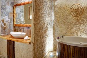 a bathroom with a sink and a bath tub at Petra Inn Cappadocia Luxury in Uçhisar +54 photos