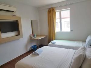 Postel nebo postele na pokoji v ubytování Santai Morib Hotel