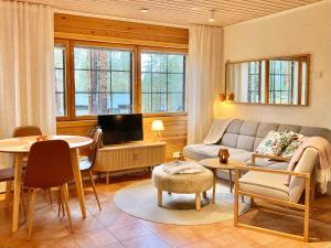 a living room with a couch and a table at Hippu Holiday Home in peaceful location near Äkäslompolo in Äkäslompolo